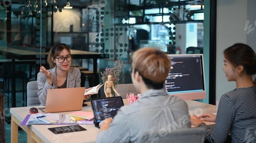 Preview: Young creative team of designer developing a new project in modern office.