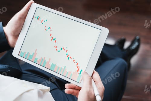 Preview: Businessman, investor,trader analyzing,looking at chart of stock prices in tablet. CEO,general manag