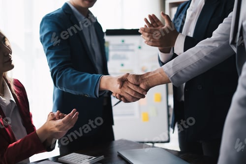 Preview: Professional businessman shaking client hand, closing successful deal.