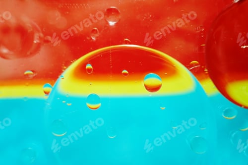 Preview: A beautiful and vibrant macro of oil bubbles on water with a yel