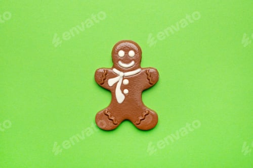 Preview: Chocolate figurine of a gingerbread man on a green background , New year and Christmas holidays