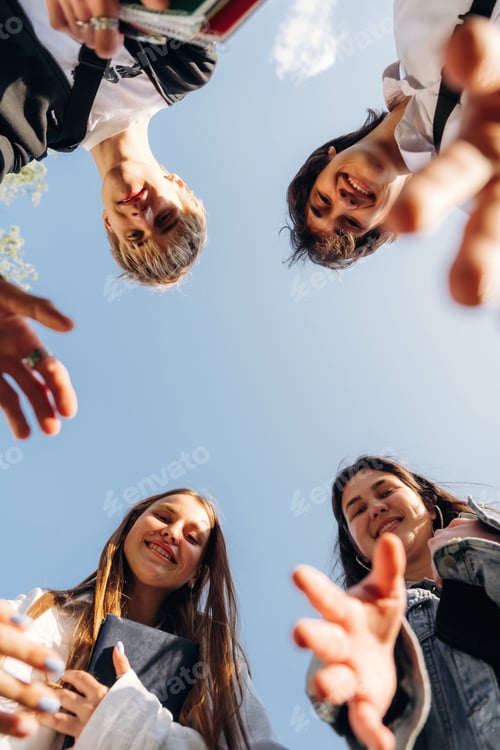 Preview: View from below of young friends against the sky