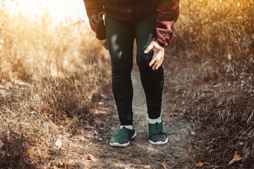 Preview: Runner running knee injury. Hands holding knee with painful. Fitness healthy lifestyle concept.
