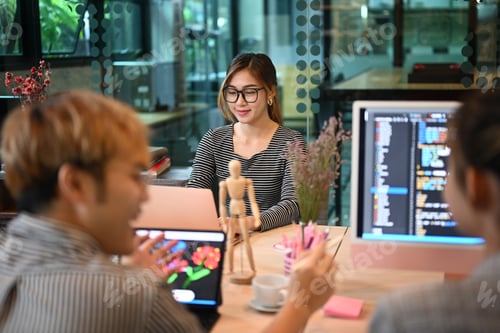 Preview: Software engineers brainstorming and working together in software development office.