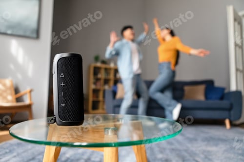 Preview: Unrecognizable Couple Listening To Song Via Wireless Smart Speaker Indoor