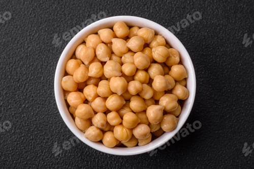 Preview: Delicious canned chickpeas in a ceramic plate on a dark concrete background