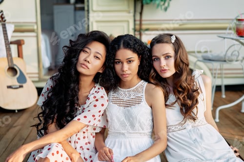 Preview: Beautiful multi ethnic girls posing near camper van outdoors