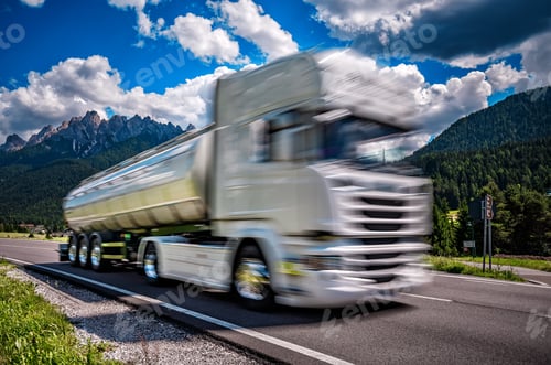 Preview: Fuel truck rushes down the highway in the background the Alps. T