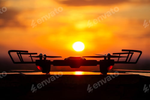 Preview: drone drone on a sunset background stands on a table