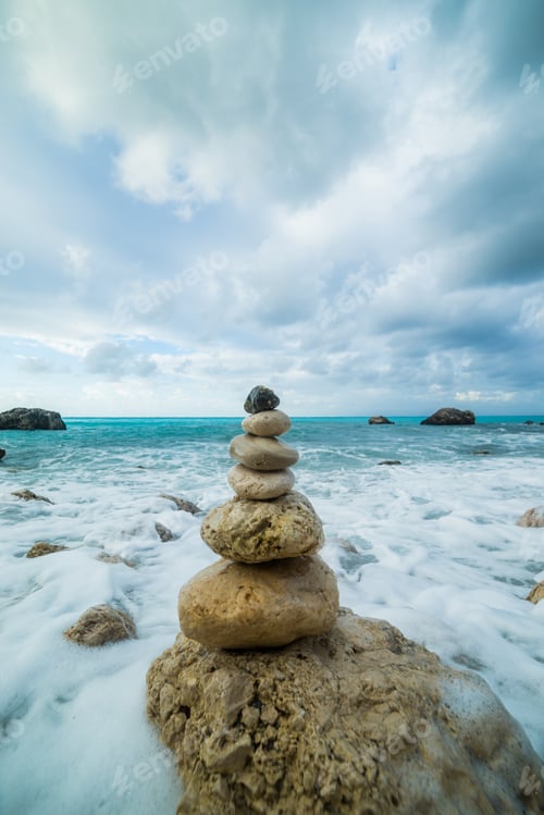 Preview: Sea dramatic landscape, harmony environment and zen stones tower silhouette. Meditation photography