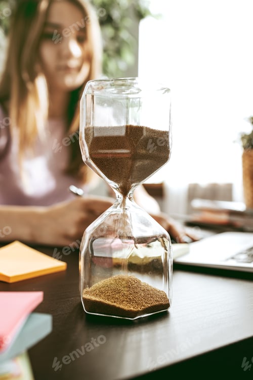 Preview: Close up of a woman writing something on the paper in office