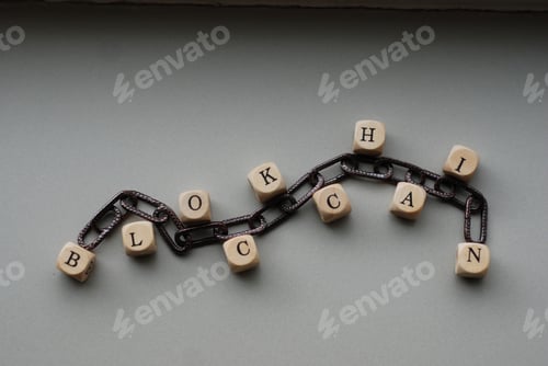Preview: Word 'Blockchain' made with wooden letter beads put on a white surface