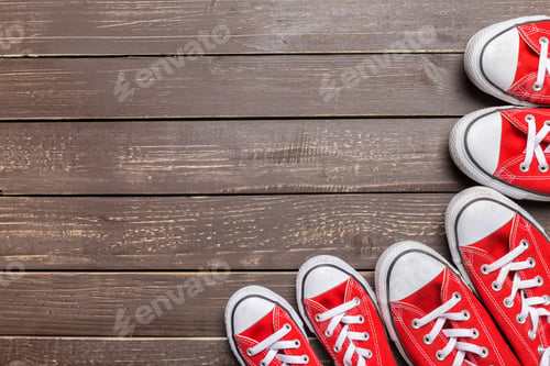 Preview: Red shoes in a row on a wooden surface during daylight