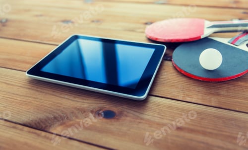 Preview: close up of table tennis rackets and tablet pc
