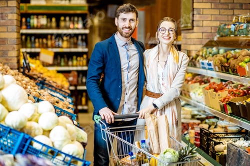 Preview: Young couple with shopping cart in the supermarket