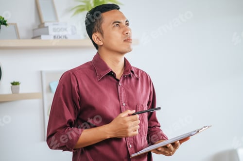 Preview: man working in office and holding documents