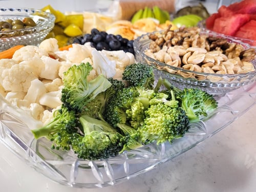 Preview: Overhead food flat lay charcuterie board at party.