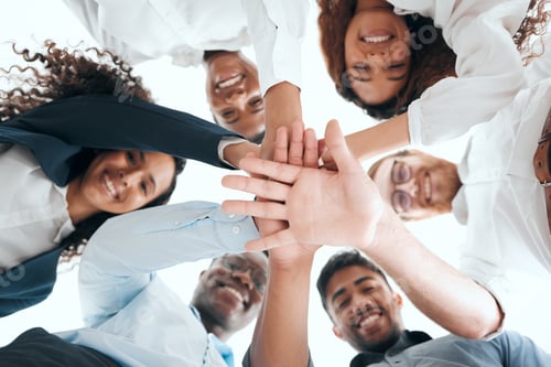 Preview: Shot of a group of businesspeople standing with their hands stacked in an office at work
