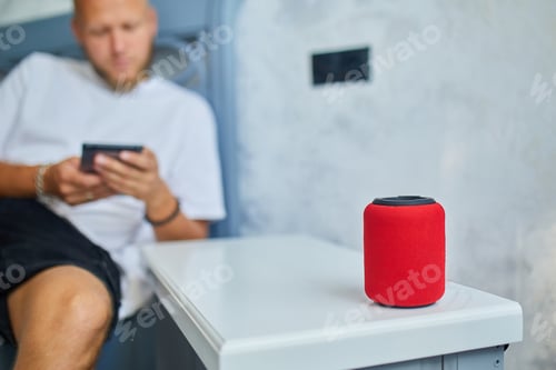 Preview: Male testing talking smart wireless speaker, man controlling home devices with a voice commands