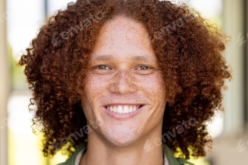 Preview: Smiling Person with Curly Hair Outdoors