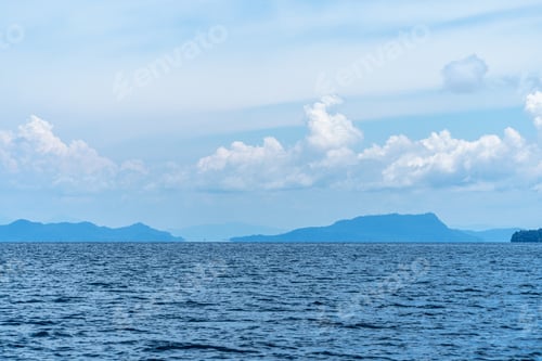 Preview: Beautiful blue clear sky and clouds over the island and calm sea waves in summer