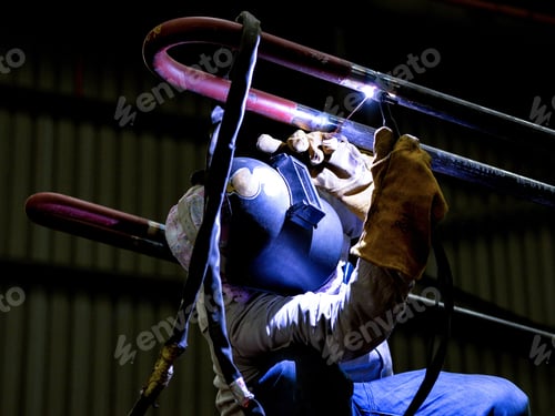 Preview: A close-up of steel welder working on a pipe connecion in a factory in Kuala Lumpur, Malaysia
