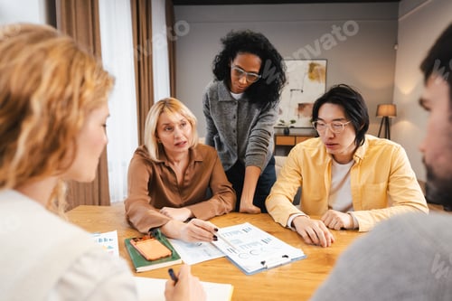 Preview: Diverse group of business team collaborating during office meeting in modern office