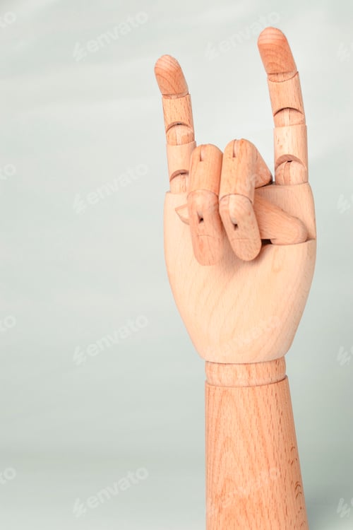 Preview: Wooden hand raised with the heavy metal symbol.