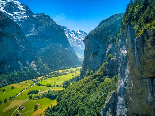 Preview: Aerial view of Lauterbrunnen Village in Switzerland surrounded by forested mountains