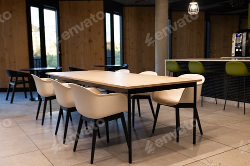 Preview: Modern office break room with empty chairs and table, ready for meetings, copy space