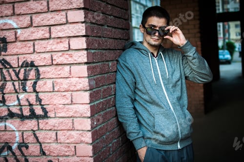 Preview: Portrait of a young man with glasses on the street