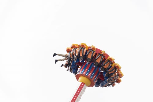 Preview: People upside down riding on an amusement park ride.