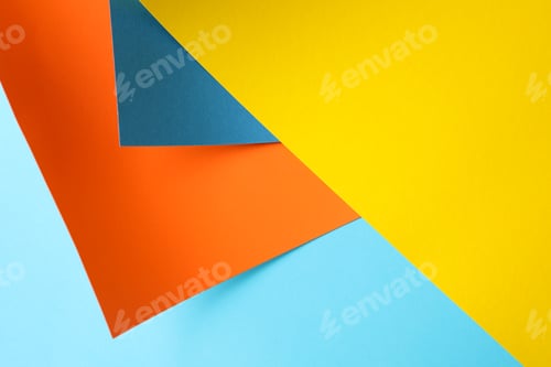 Preview: Background made of color sheets: yellow, orange and blue, close up