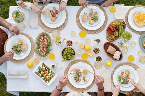 Preview: Multiethnic Group of Adults Enjoying Outdoor Summer Lunch Gathering Together