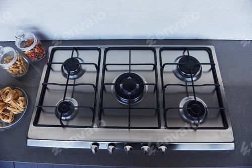 Preview: Close up view of top of a gas stove indoors near wall at daytime
