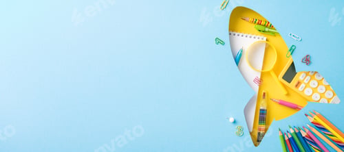 Preview: Creative arrangement of school supplies in the shape of a rocket on a light blue background