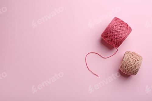 Preview: Clews of knitting threads on color background, flat lay with space for text. Sewing stuff