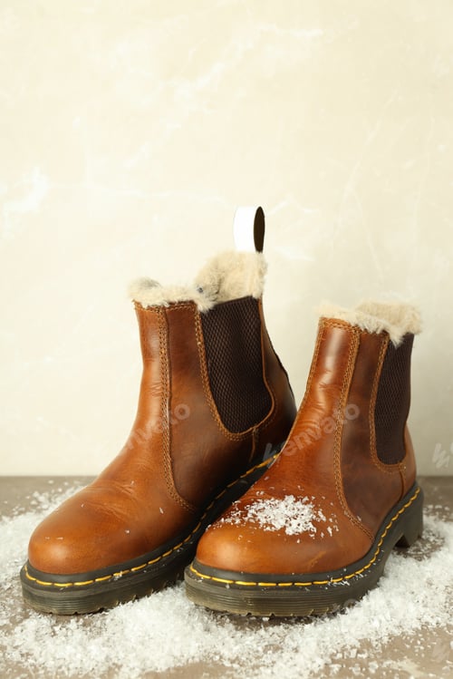 Preview: Boots with snow on gray textured table
