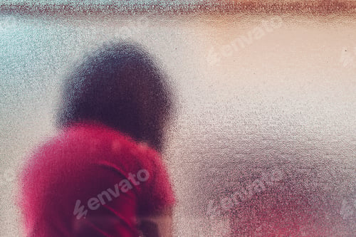 Preview: Silhouette of unrecognizable sad autistic girl behind stained gl