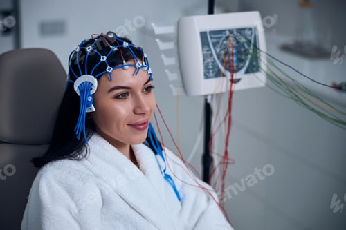 Preview: Pleased female patient undergoing an EEG test