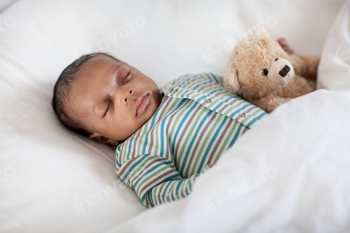 Preview: Sleeping baby in bed with teddy bear