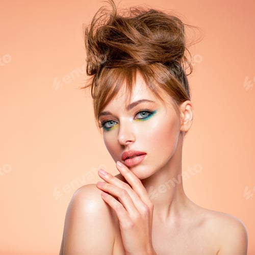 Preview: Face of an young girl close-up with a green color makeup. Stylish makeup.