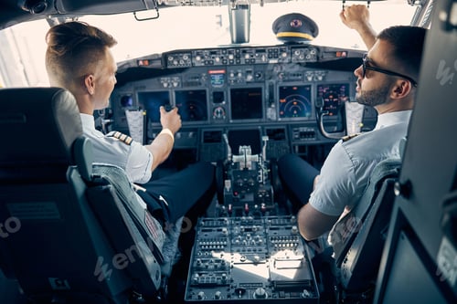 Preview: Two handsome man sitting on the chair in cockpit