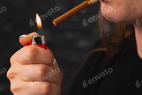 Preview: Unrecognizable woman lights cigarette with fire lighter