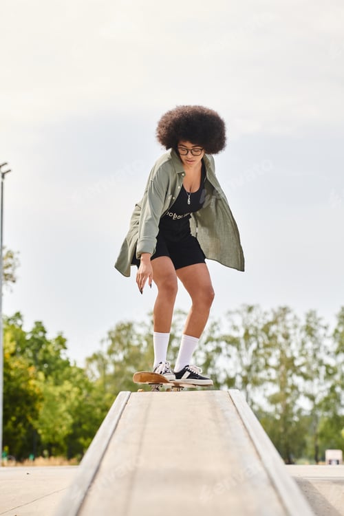 Preview: Urban glide: bold african american woman skateboarding on ledge