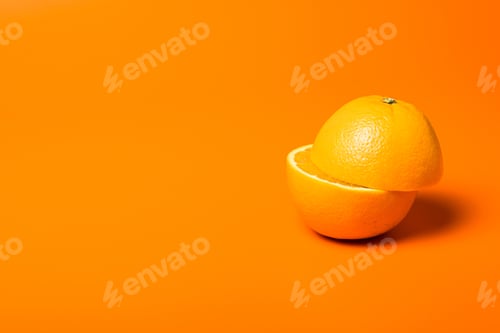 Preview: Closeup shot of a juicy half cut orange on orange background