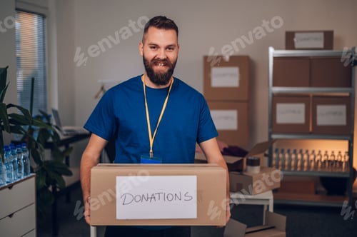 Preview: Portrait of a man volunteer working in a charity donation center
