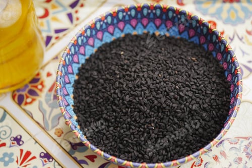 Preview: black cumin seed in a colorful bowl on a patterned table