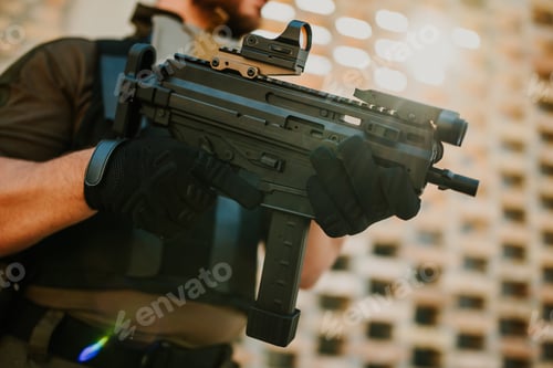 Preview: Soldier holding a modern submachine gun with red dot sight and tactical gloves