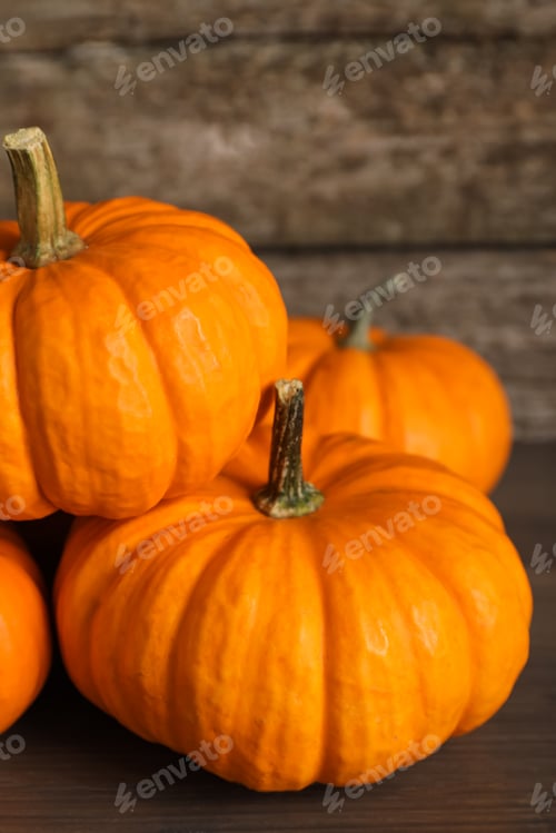 Preview: Fresh ripe pumpkins on wooden table, closeup